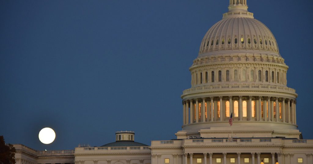 United States Capital building at night with full moon