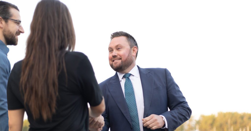 Male attorney shaking hands with potential clients