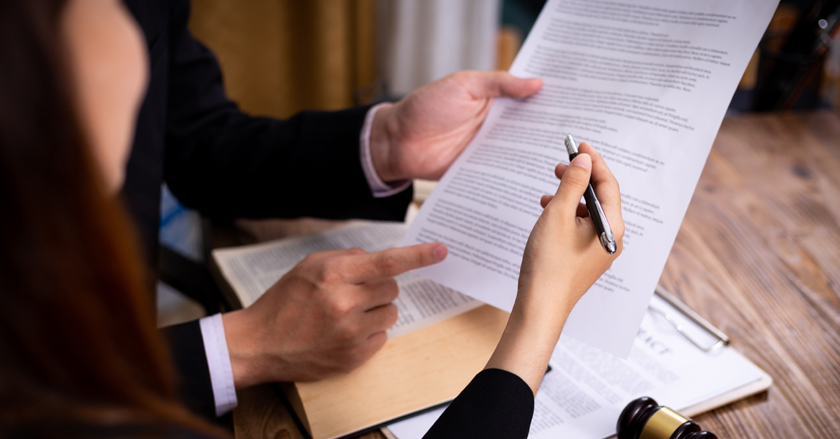 Attorney and client reviewing paperwork