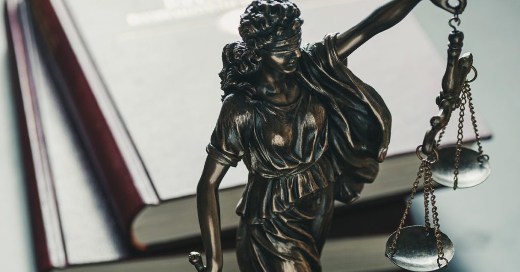 Close up of statue of the figure of justice holding scales