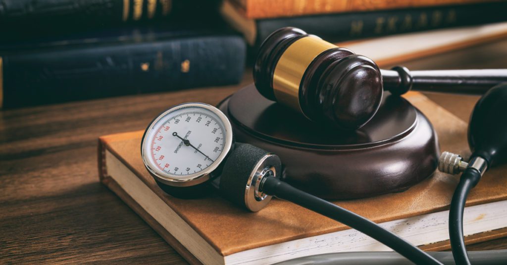 Judge gavel and a blood pressure gauge