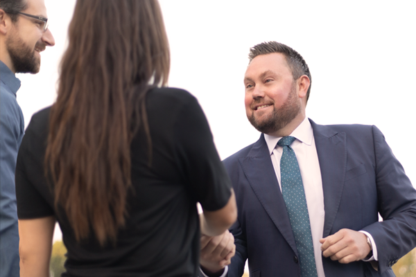 Attorney shaking hands with potential clients