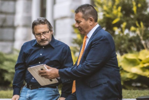 Attorney and client reviewing document together on an electronic tablet