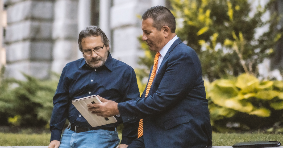 Attorney and client reviewing document together on an electronic tablet